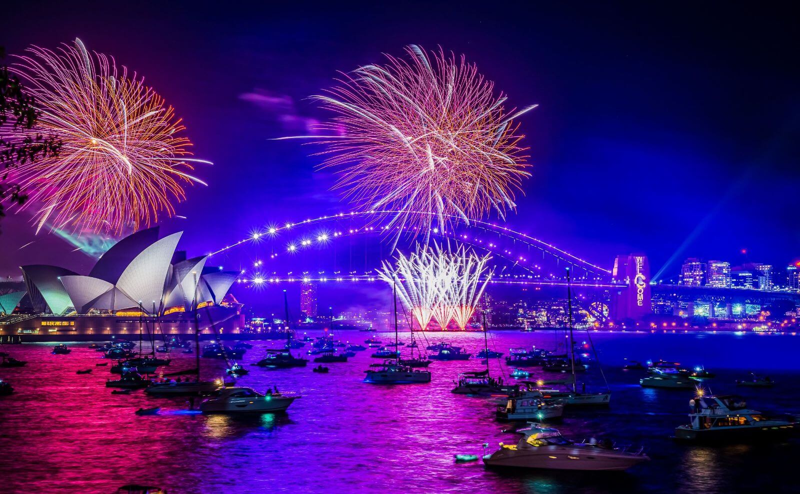 Màn trình diễn pháo hoa rực rỡ tại Sydney Harbour, Australia với biểu tượng Nhà hát Opera Sydney và cầu Harbour Bridge, tạo nên một trong những lễ hội đón năm mới hoành tráng và nổi tiếng nhất thế giới.